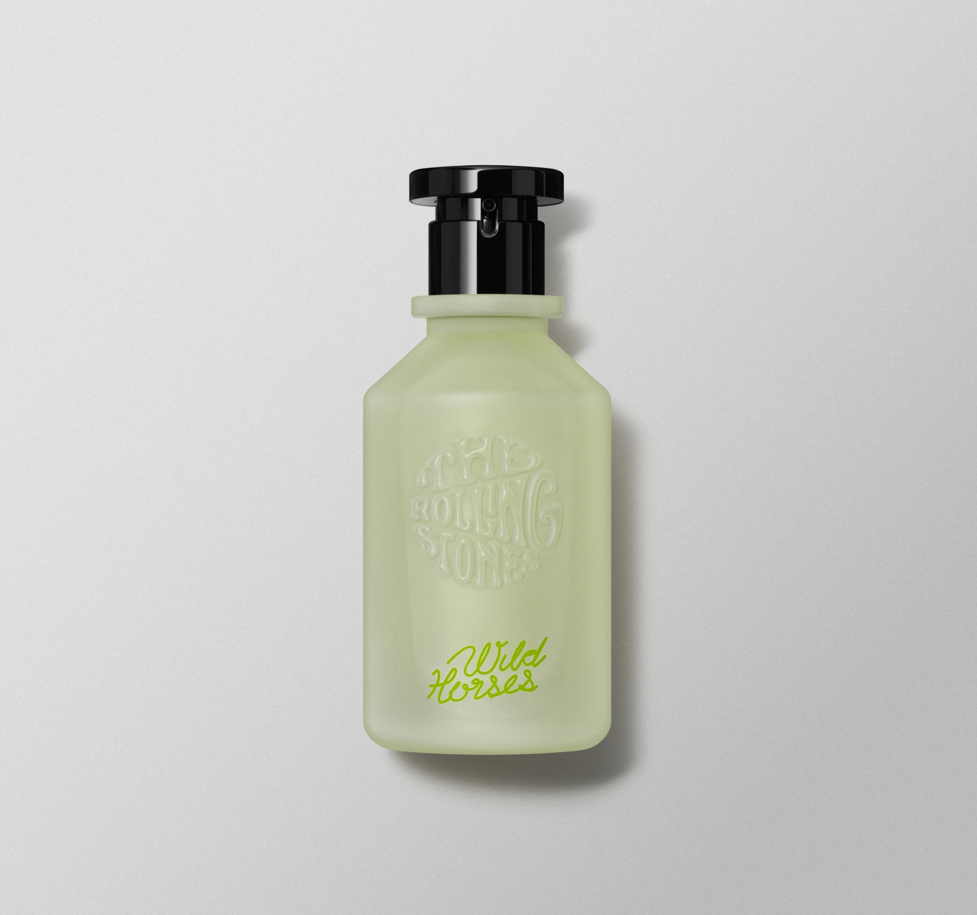 A perfume bottle with a green tint and a black cap, labeled 'Wild Horses' by the Rolling Stones