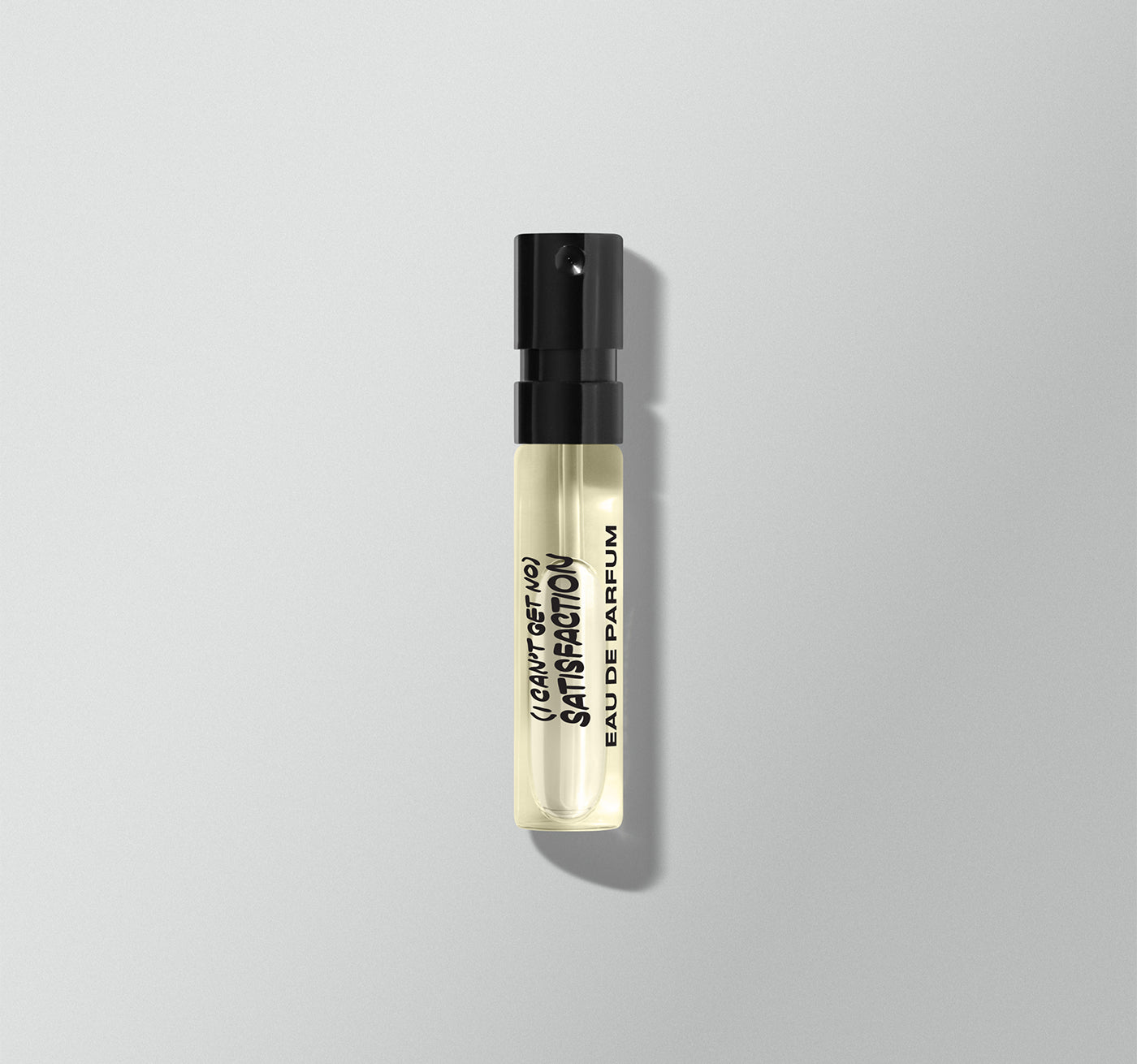 Small perfume bottle with black cap and clear body on a light gray background