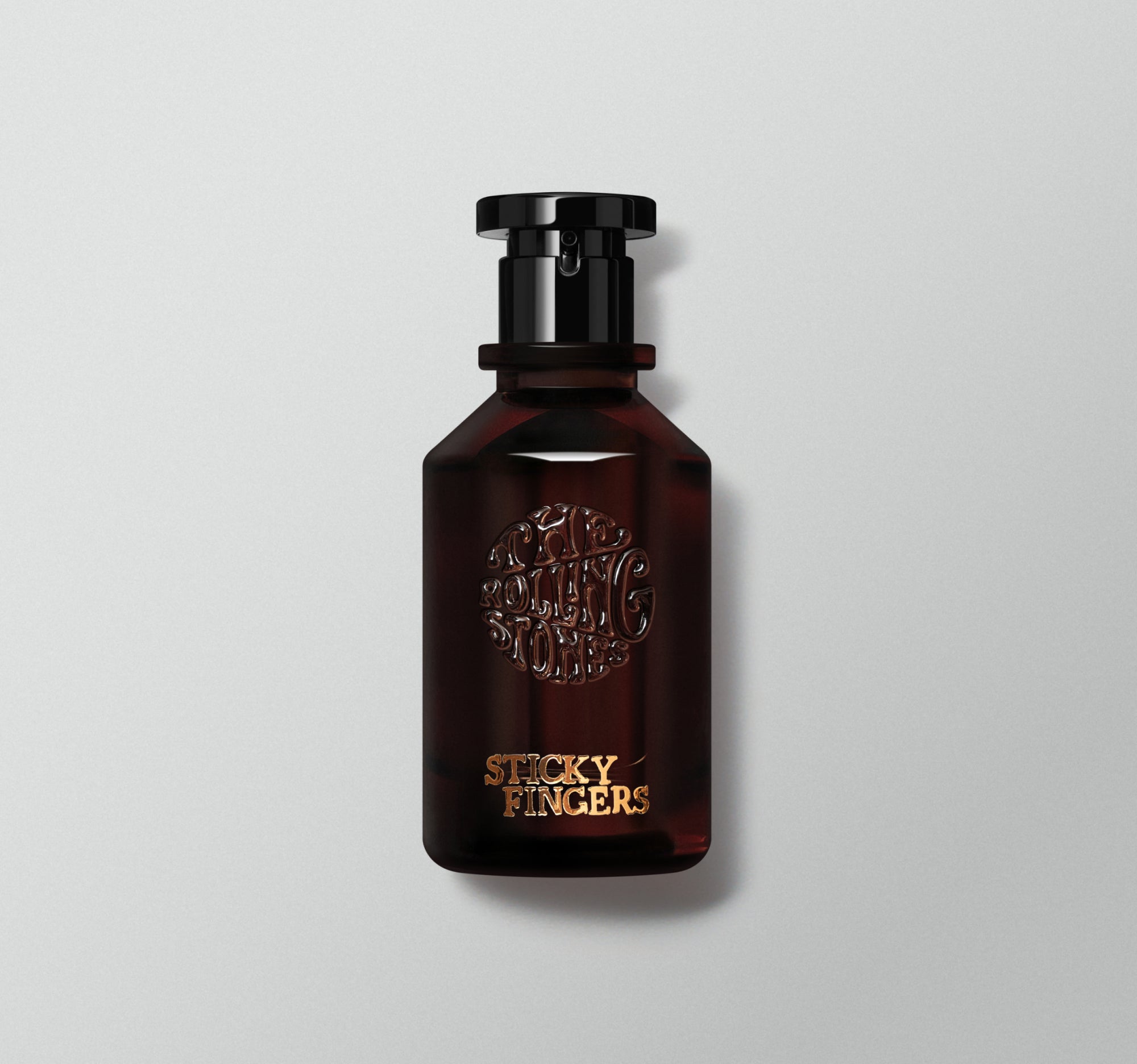 A bottle of perfume labeled 'Sticky Fingers' by the Rolling Stones with a dark liquid visible and a black cap.